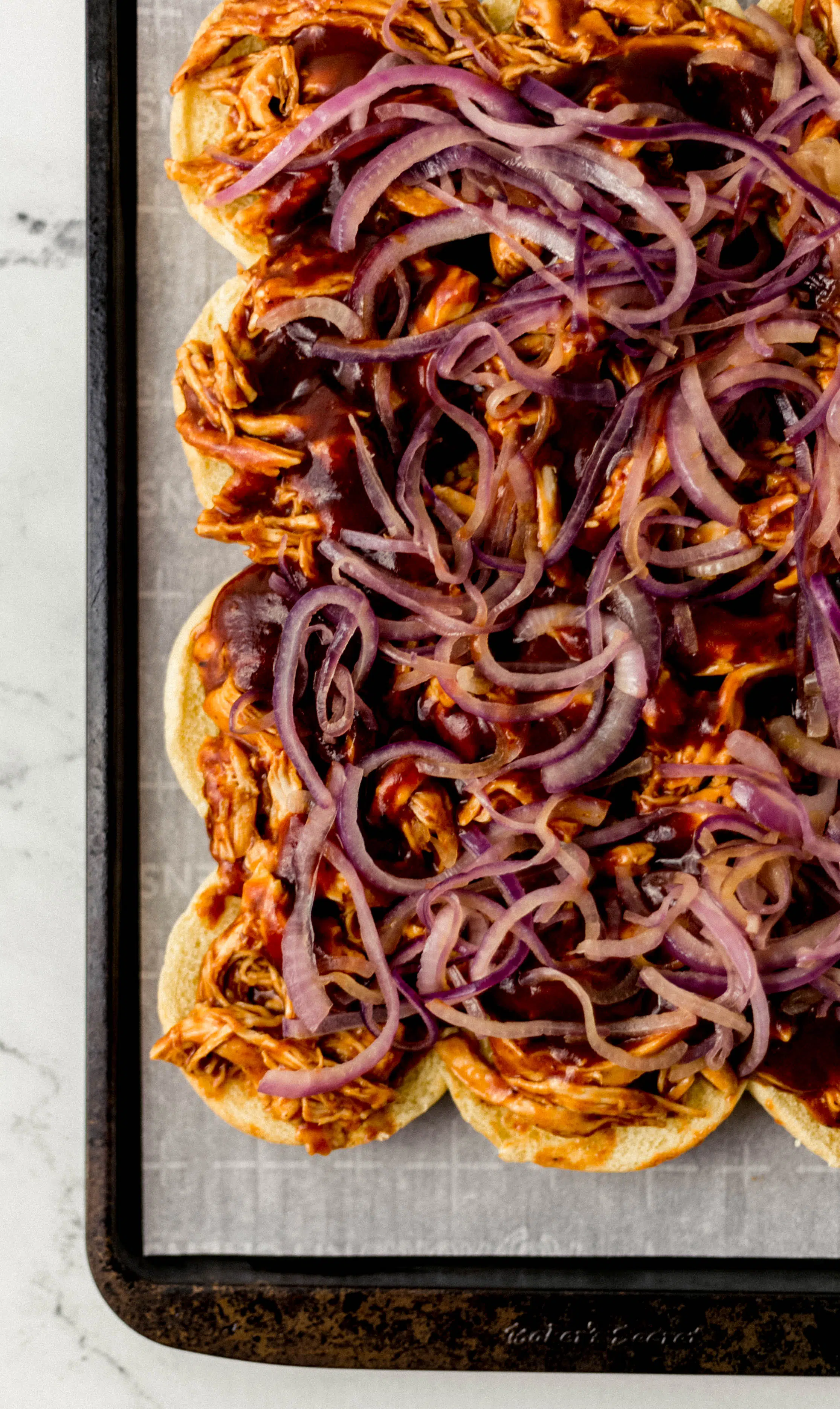 red onion spread evenly on top of bbq sliders 