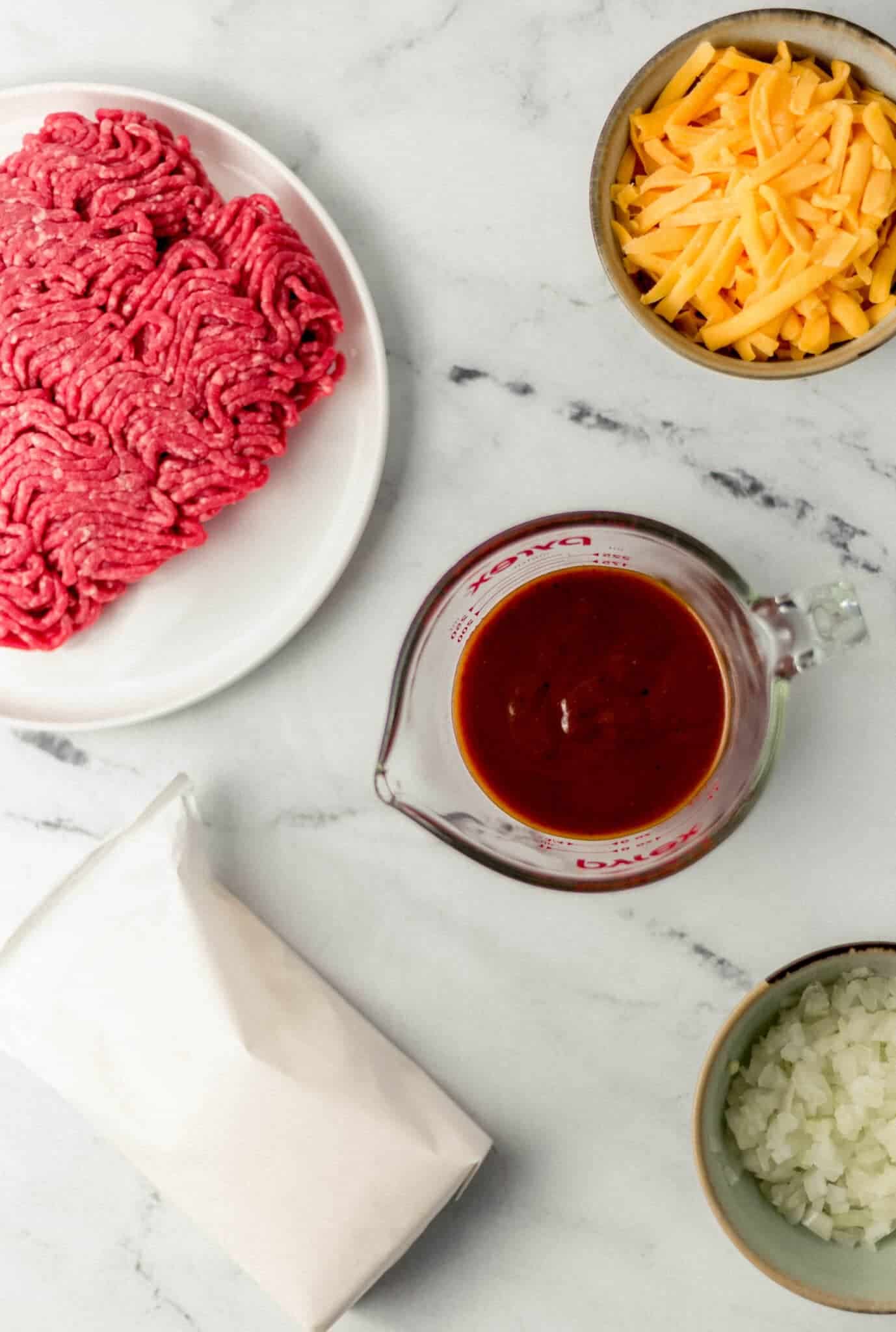 ingredients needed to make recipe in separate containers on marble surface