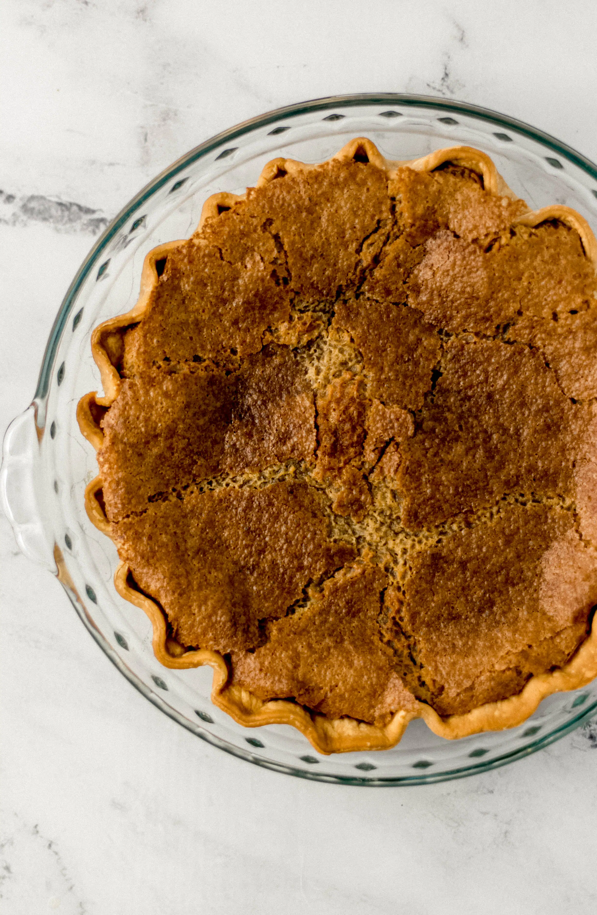 overhead view of finished brown sugar pie in glass dish