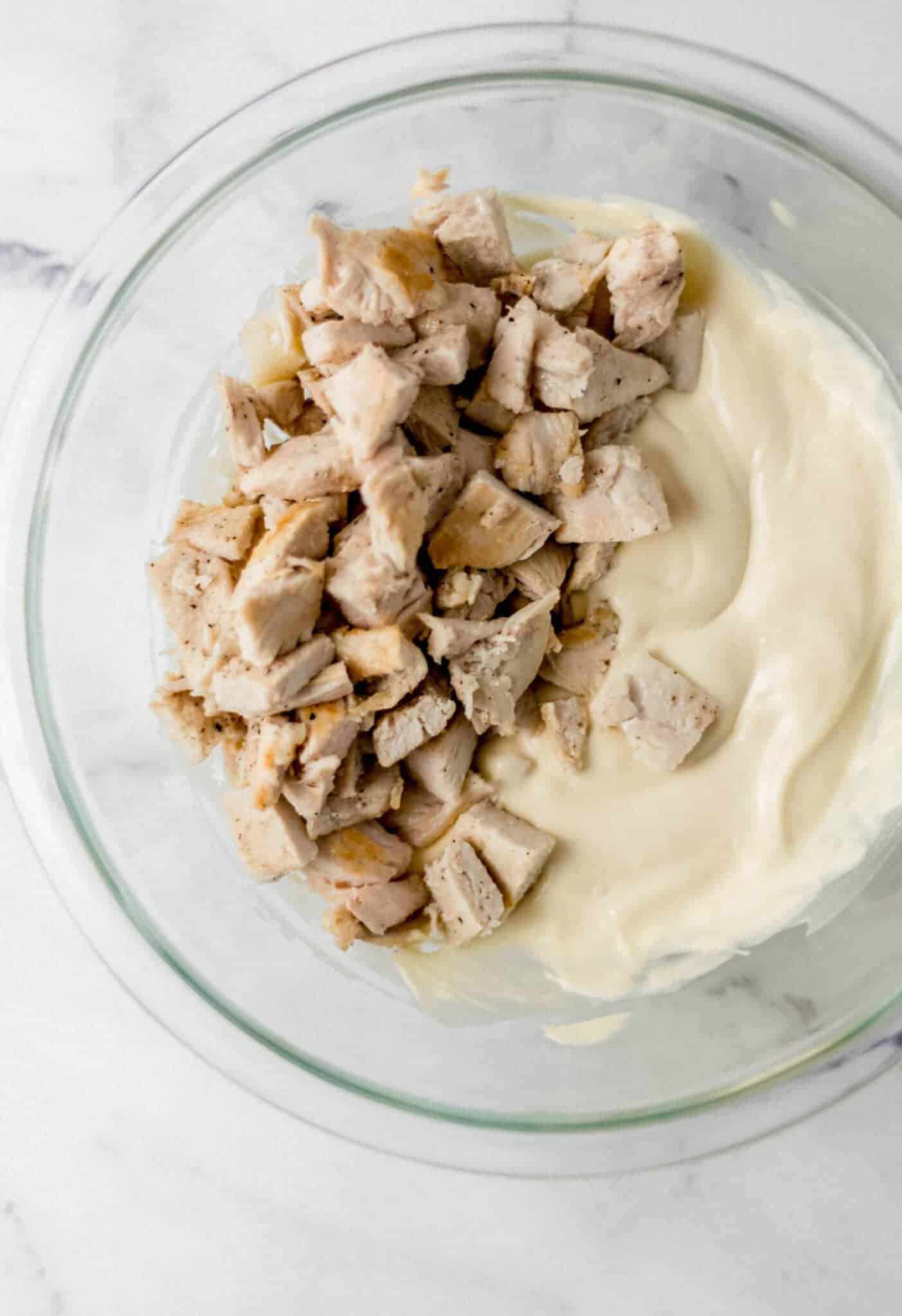 chicken, mayo, and soup combined in glass bowl 