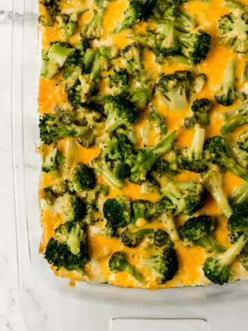 overhead view of baked chicken and broccoli casserole in rectangle glass baking dish