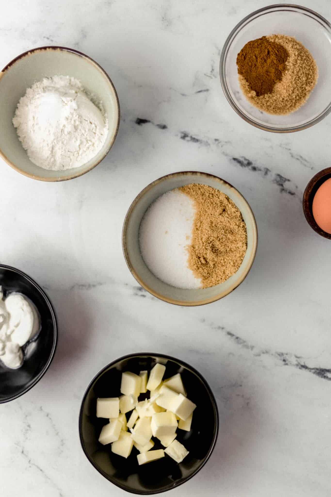 overhead view of ingredients needed to make muffins in separate bowls 