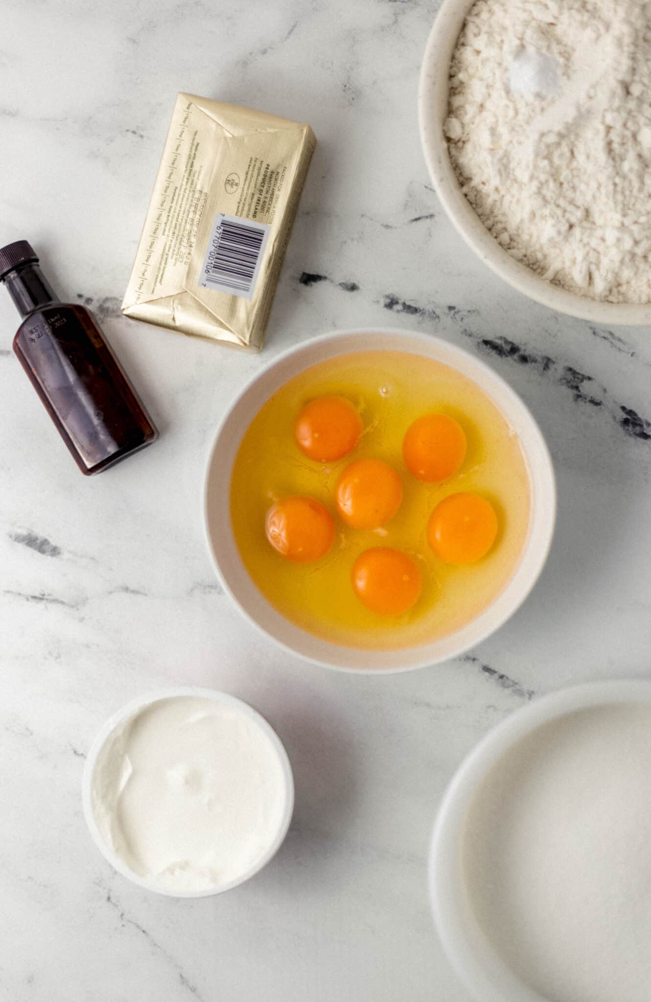 overhead view of ingredients needed to make pound cake in separate bowls and containers