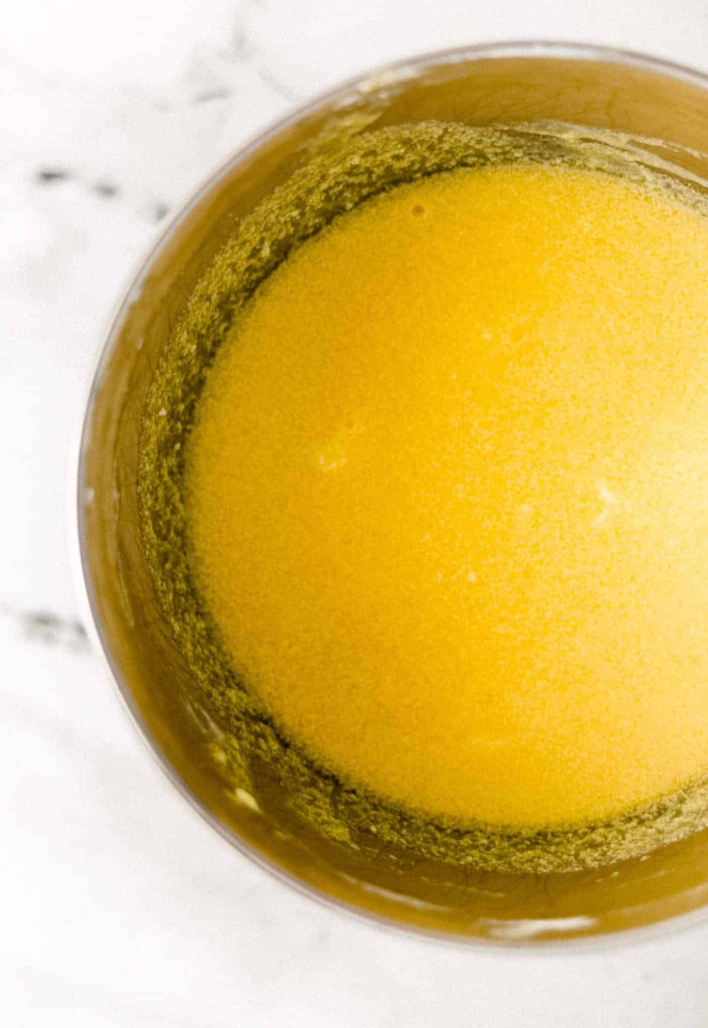wet ingredients to make pound cake combined together in stand mixer bowl