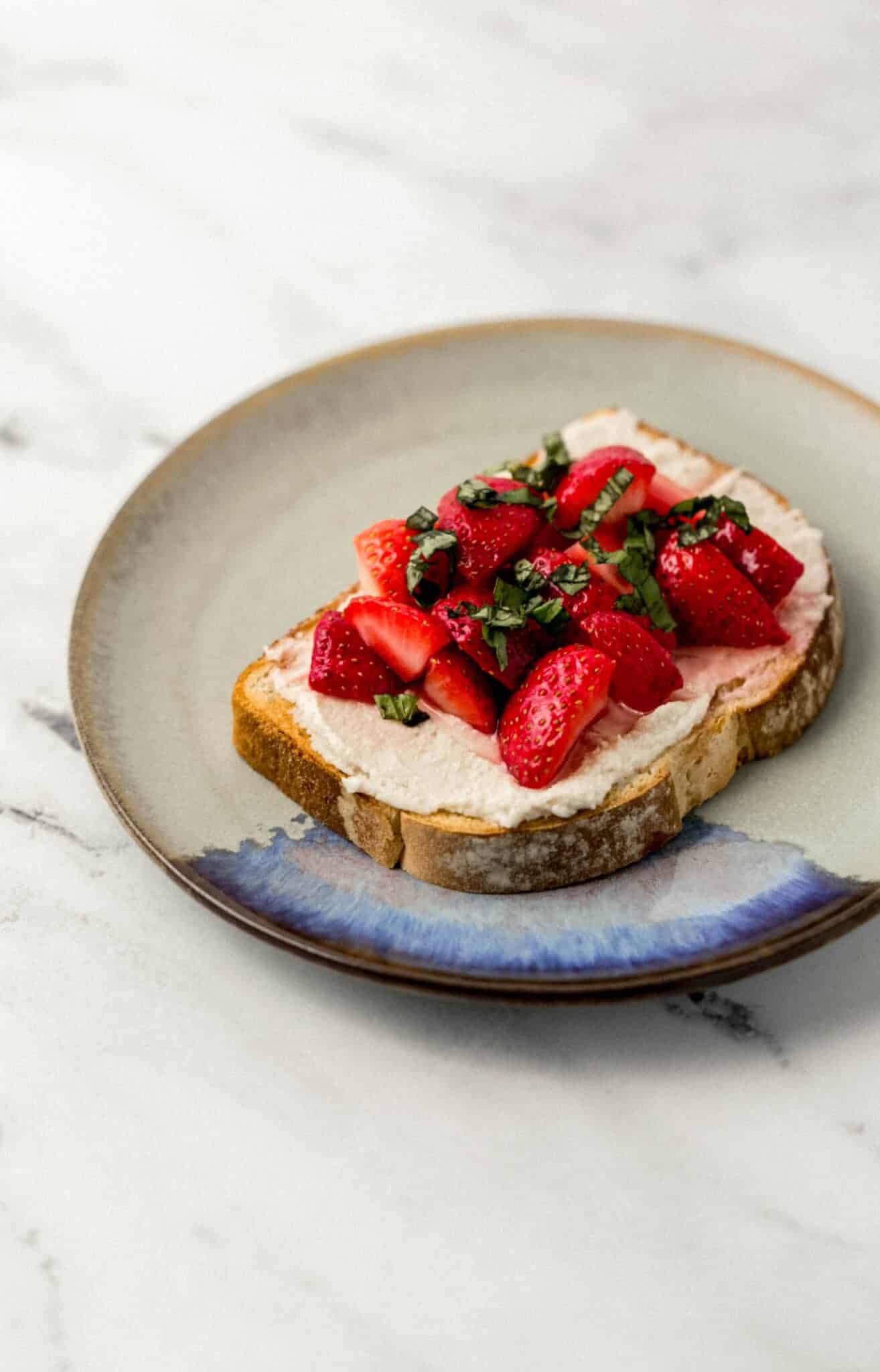 close up side view of finished strawberry toast on plate 