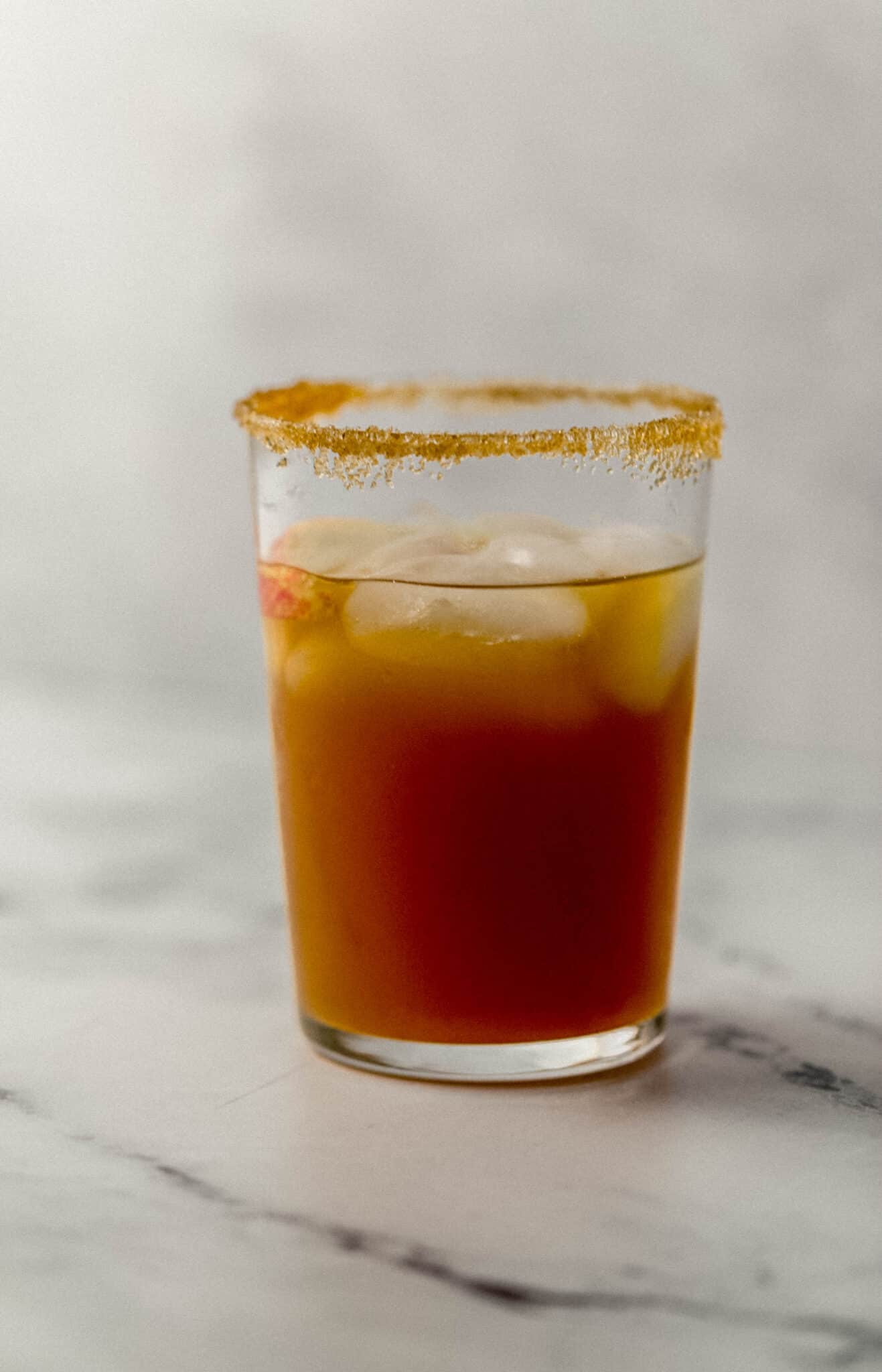 finished margarita in a glass with ice and rimmed with brown sugar