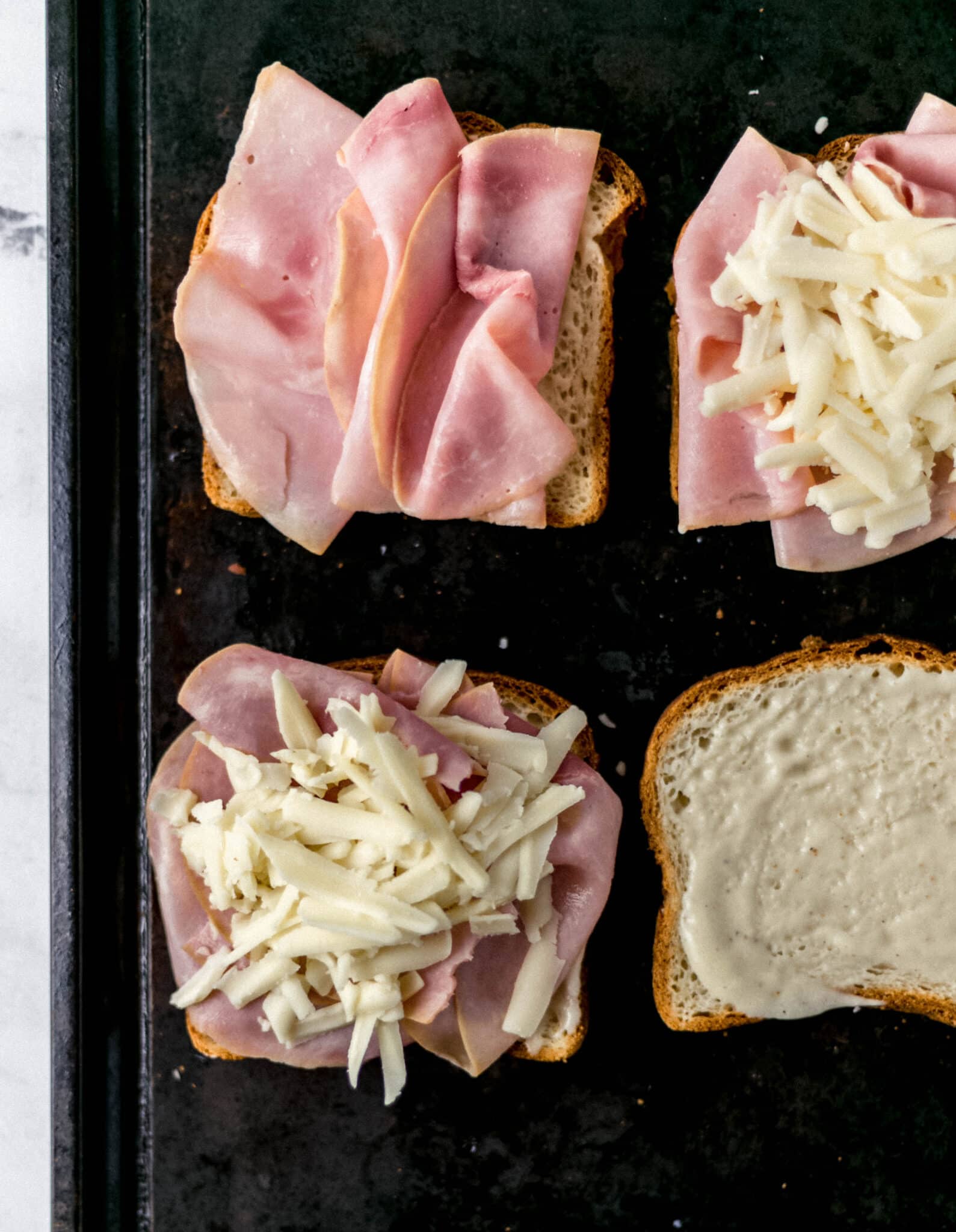 sandwiches being prepared on baking sheet