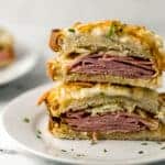 close up view of croque monsieur cut in half on white plate