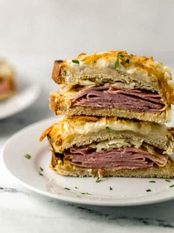 close up view of croque monsieur cut in half on white plate