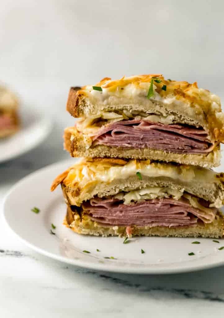 close up view of croque monsieur cut in half on white plate