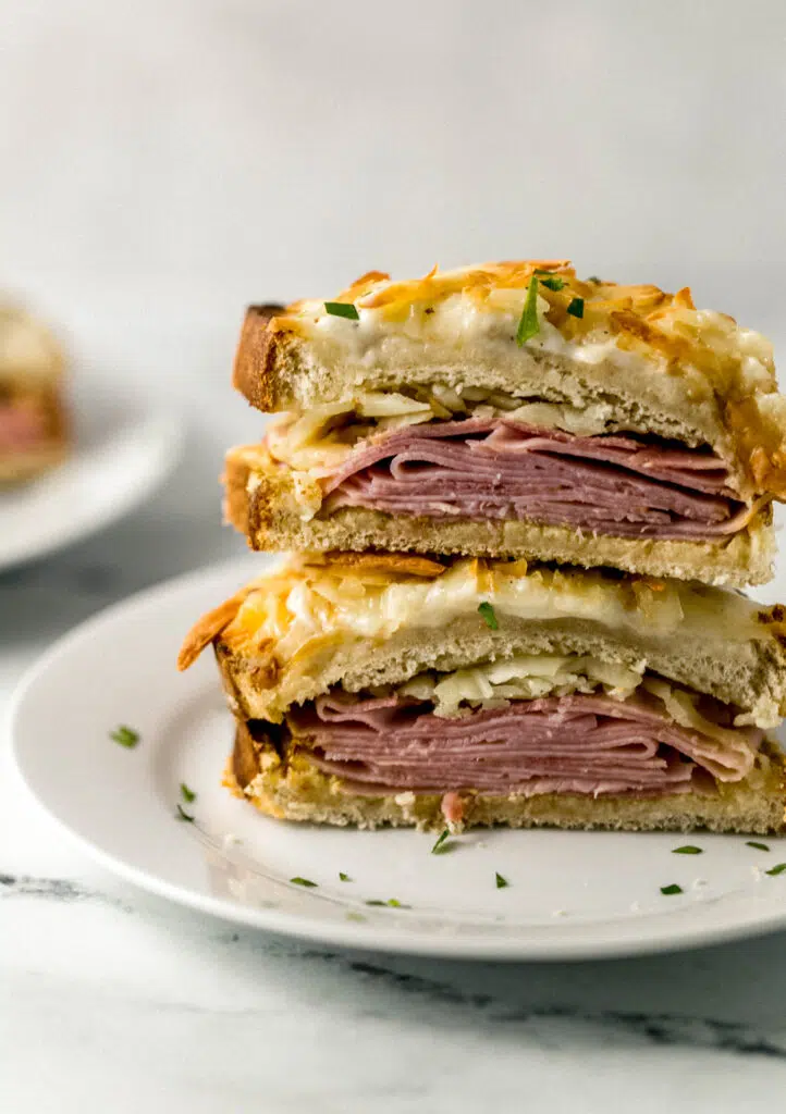 close up view of croque monsieur cut in half on white plate