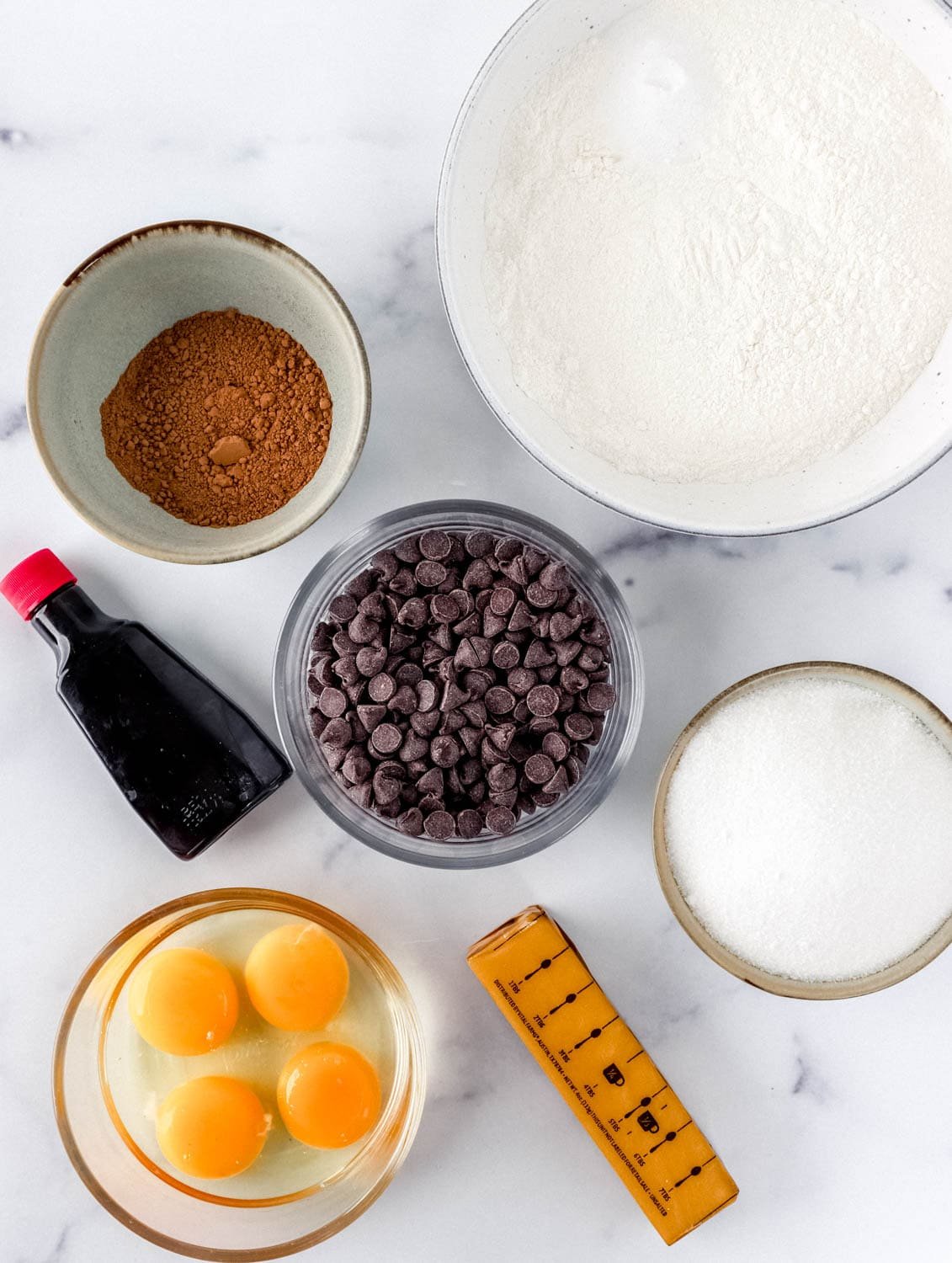 Ingredients needed to make brownies in separate bowls. 