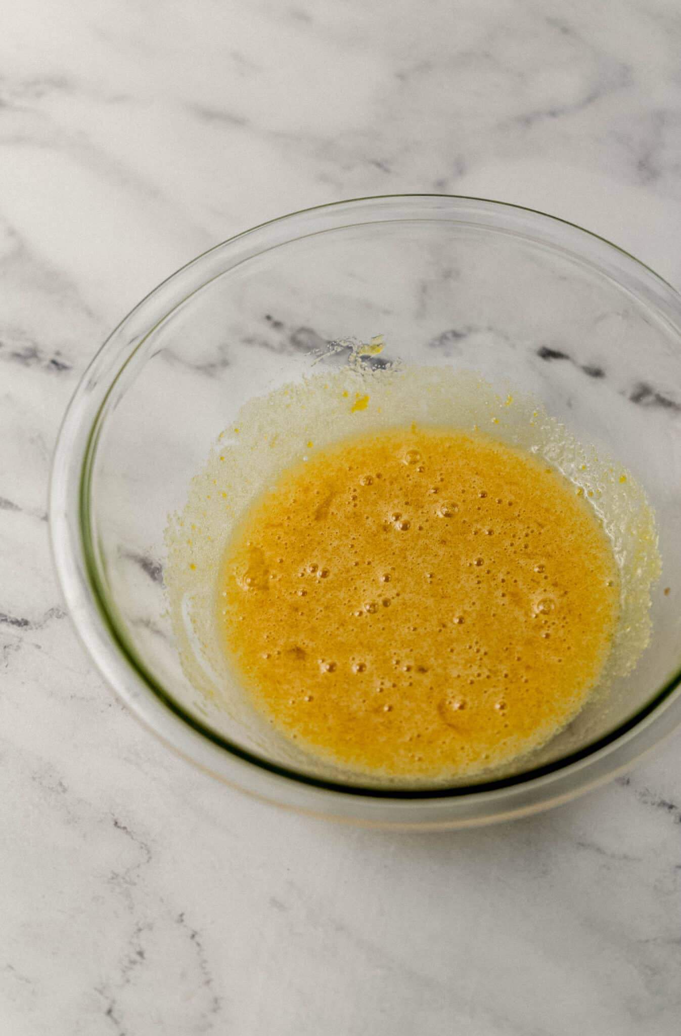 sugar, eggs, vanilla, and salt combined in glass mixing bowl 