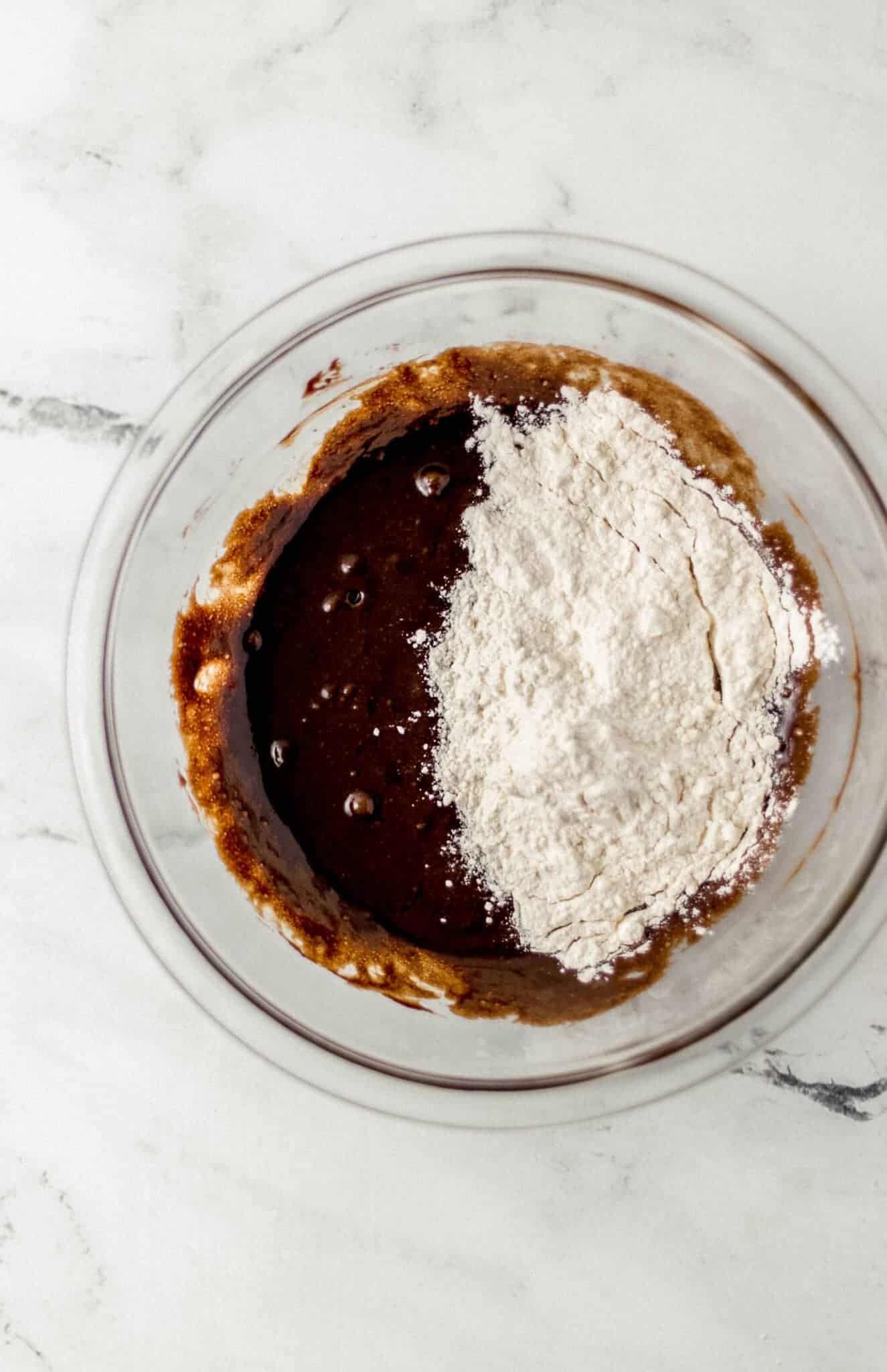 wet ingredients and flour combined in glass mixing bowl