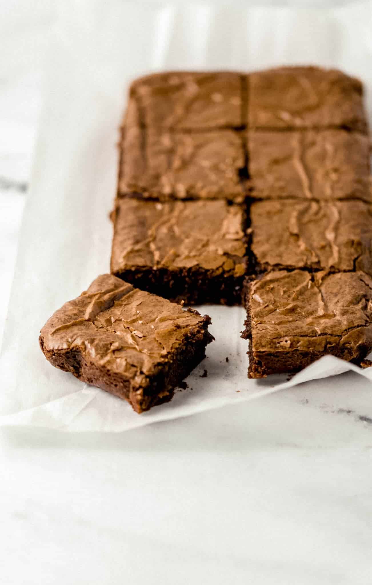 finished brownies cut into squares on parchment paper