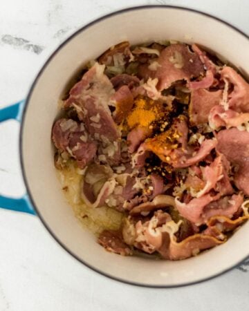 Ham, onion, and seasonings added to dutch oven.