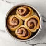 overhead view of baked small batch cinnamon rolls in silver baking pan