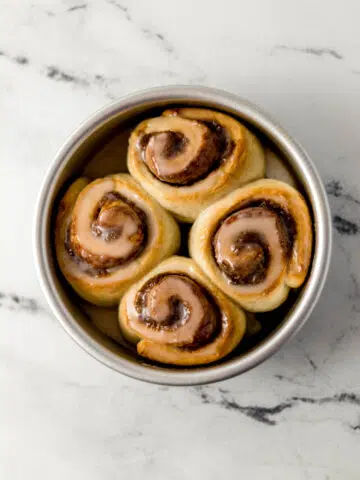 overhead view of baked small batch cinnamon rolls in silver baking pan