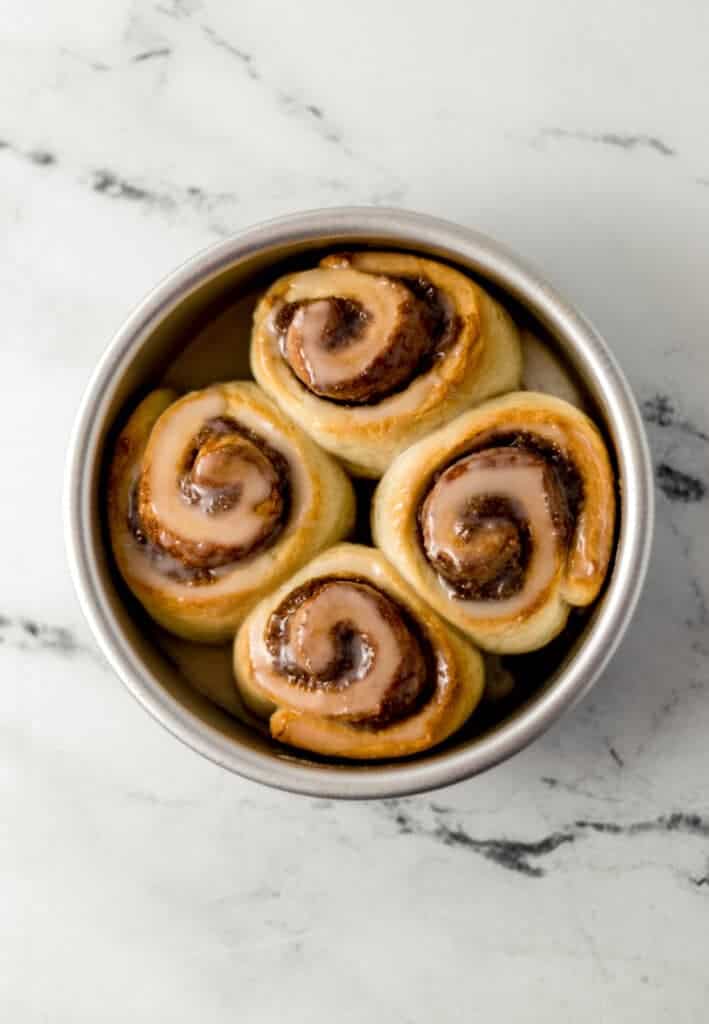 overhead view of baked small batch cinnamon rolls in silver baking pan