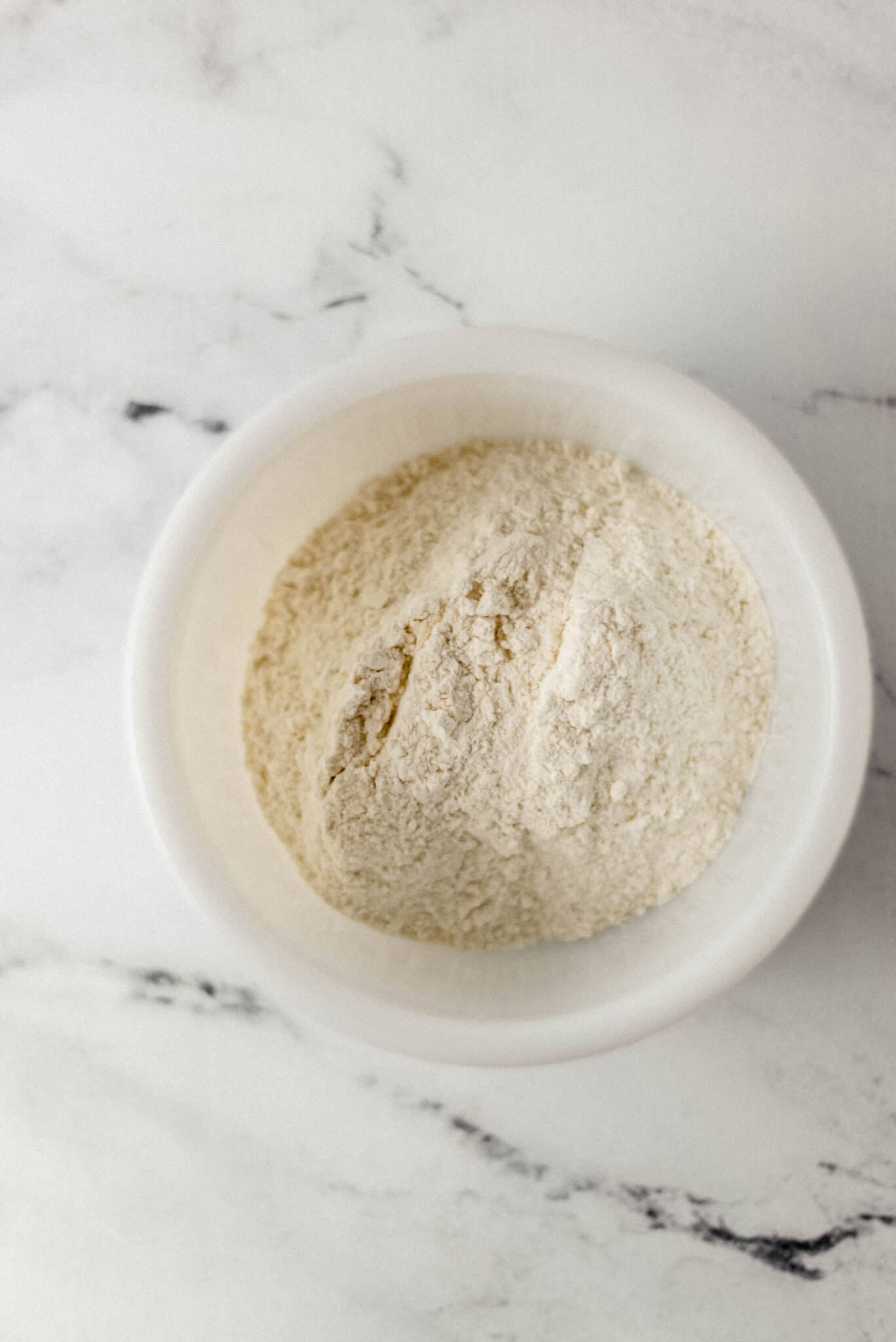 flour, salt, and sugar combined in white mixing bowl 