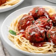 Close up side view of plate of spaghetti.