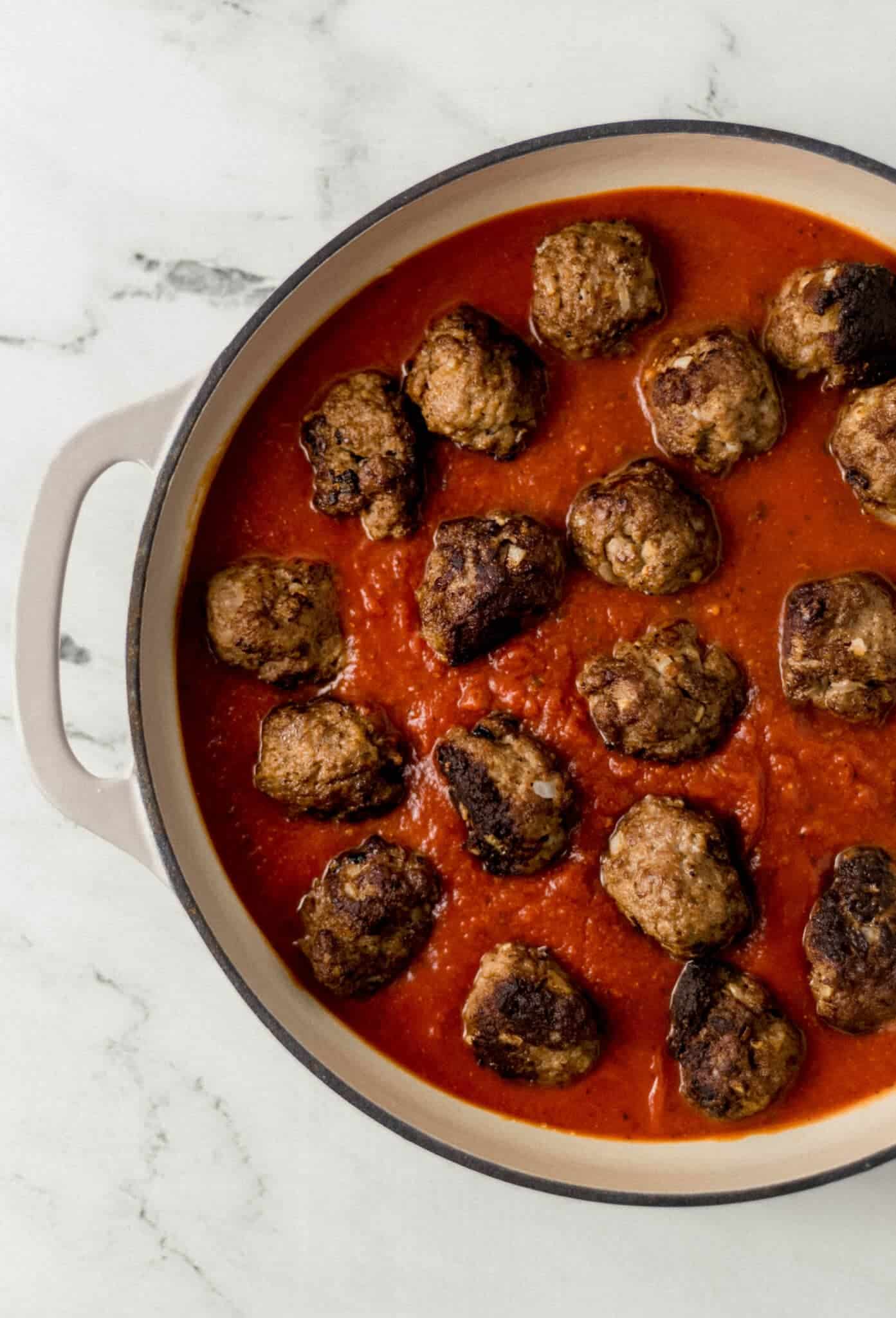 meatballs added to pan with pasta sauce 