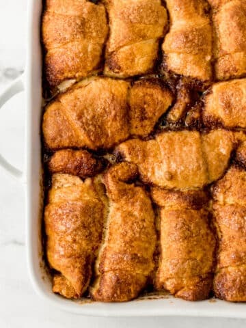 overhead view of finished apple dumplings in white baking dish