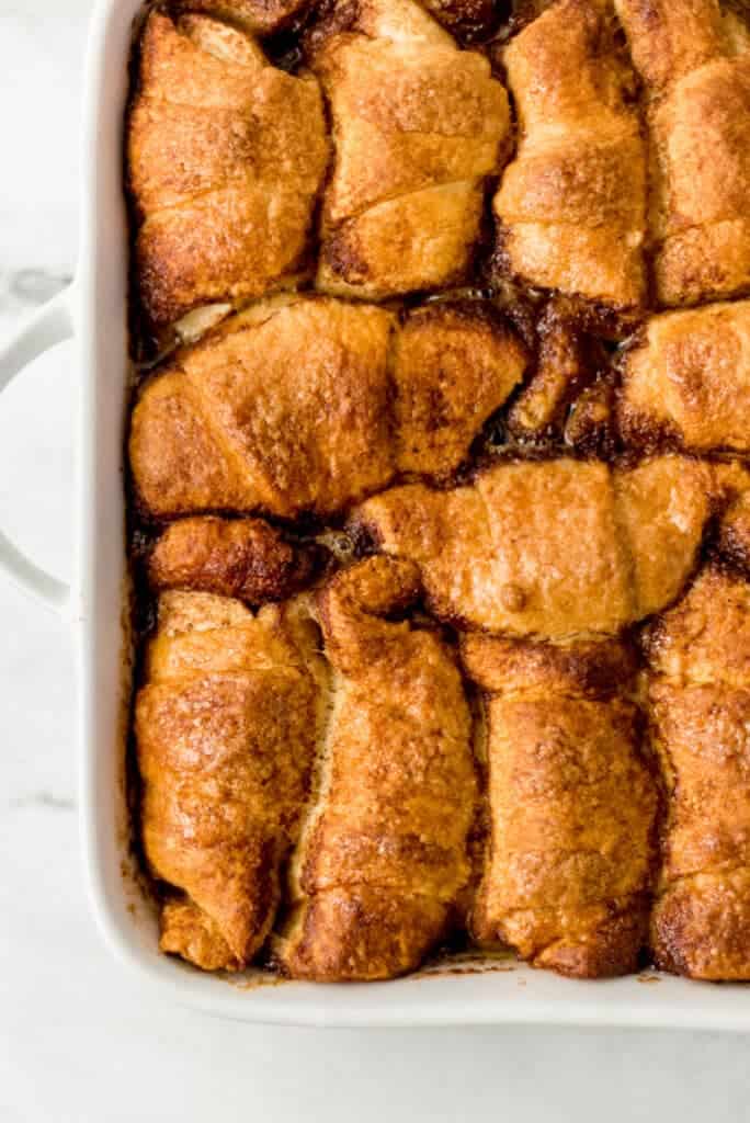 overhead view of finished apple dumplings in white baking dish