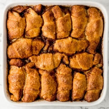 overhead view of finished apple dumplings in large square white baking dish