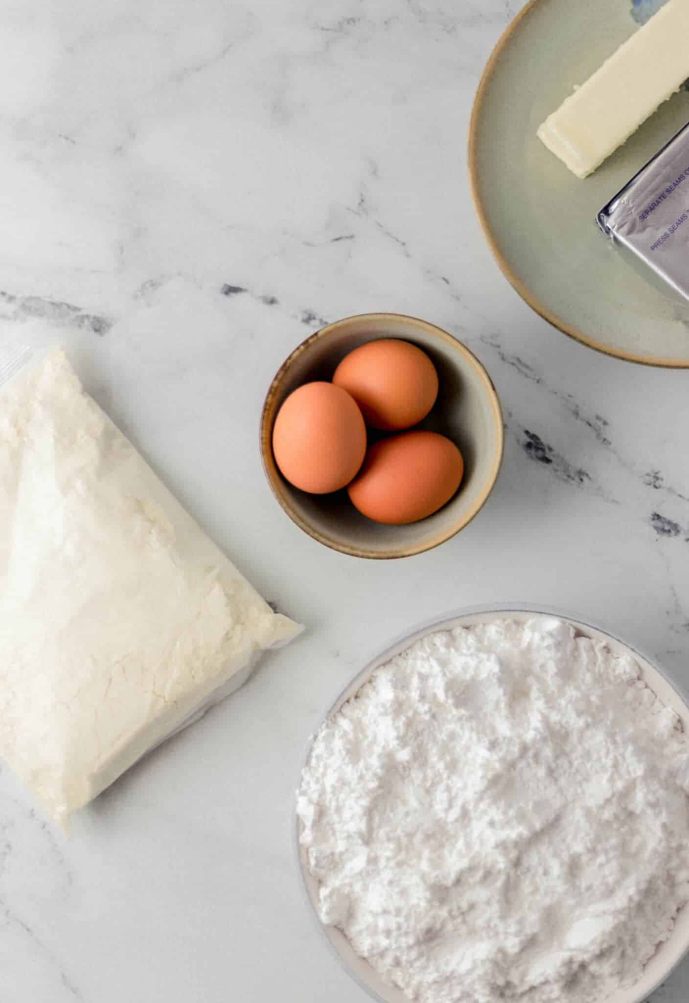 overhead view of ingredients needed to make dessert in separate bowls and packages 