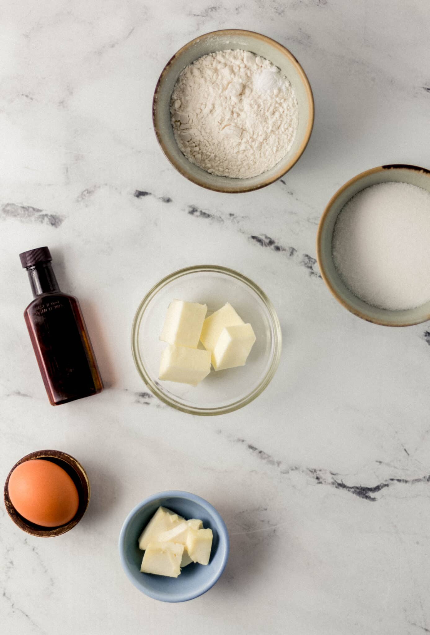 ingredients needed to make small pound cakes in separate containers