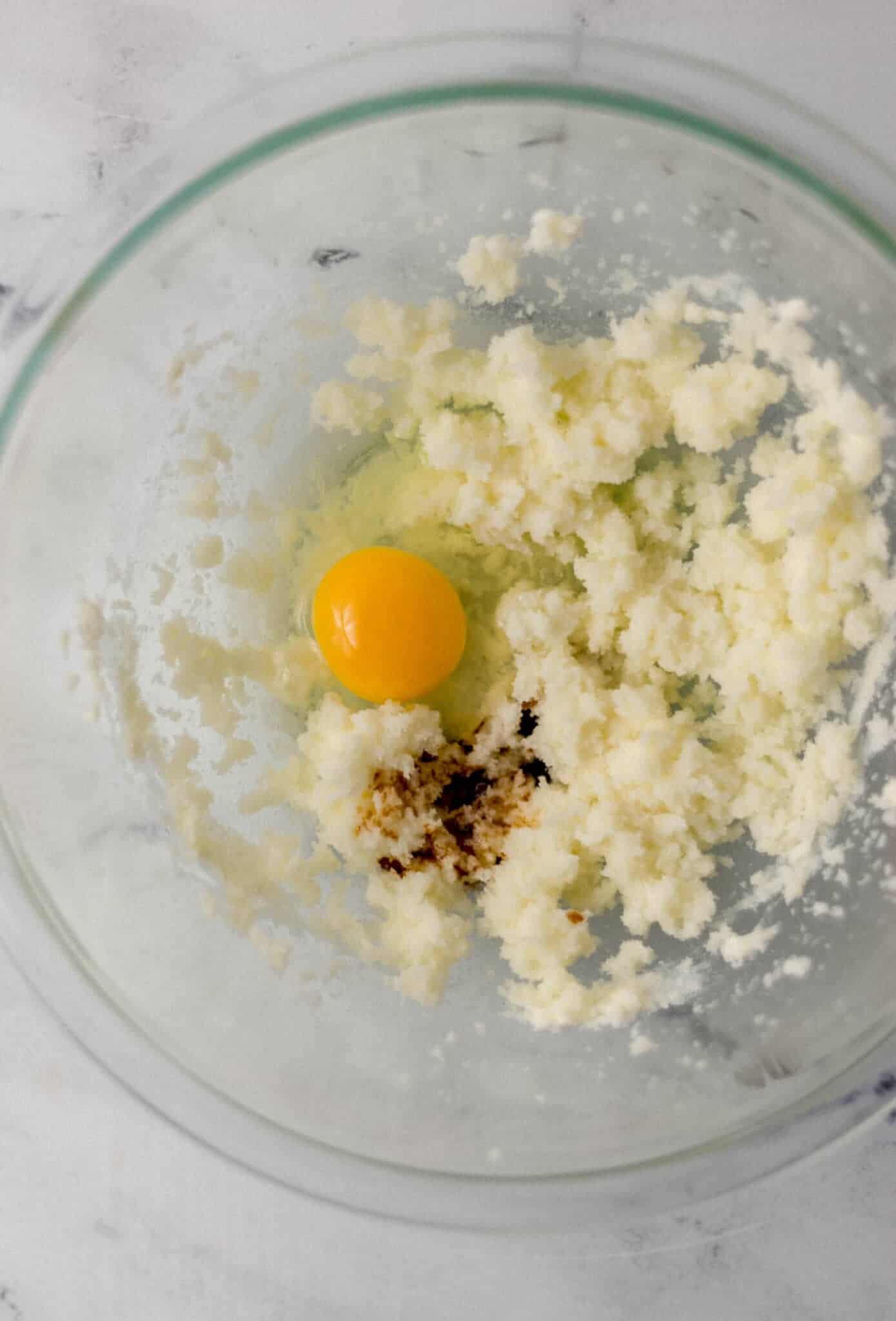 ingredients to make cake combined in glass mixing bowl 