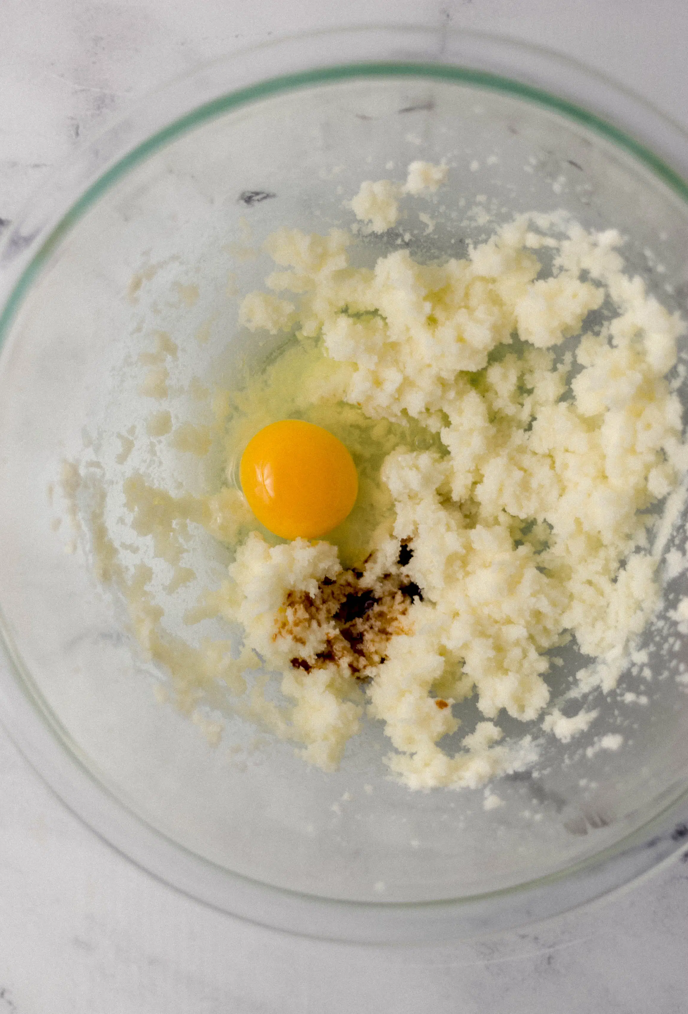 ingredients to make cake combined in glass mixing bowl 