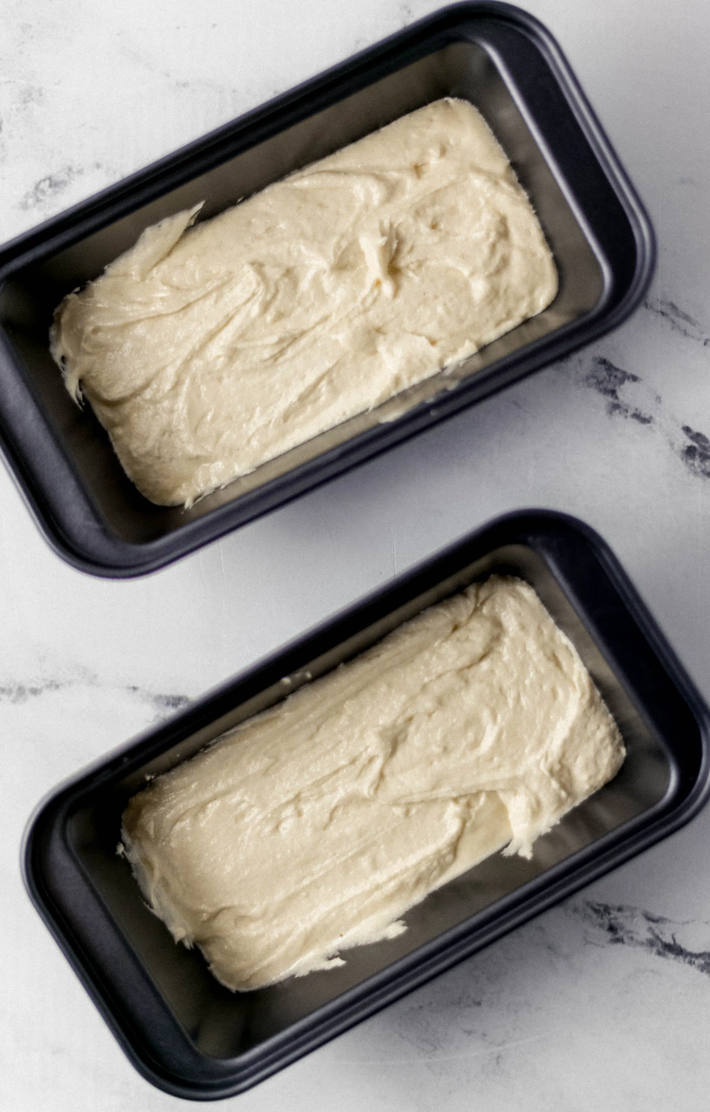 cake mix added to two mini loaf pans 
