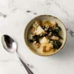 single bowl of soup beside a spoon
