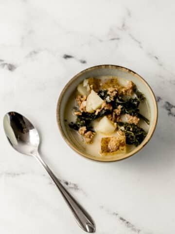 single bowl of soup beside a spoon