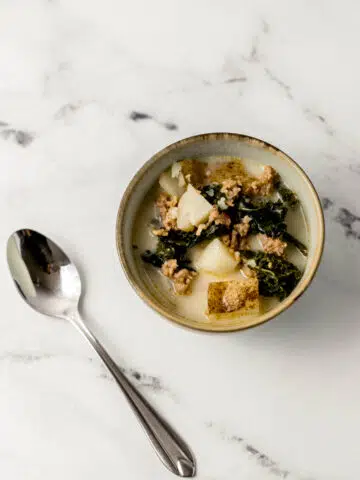 single bowl of soup beside a spoon