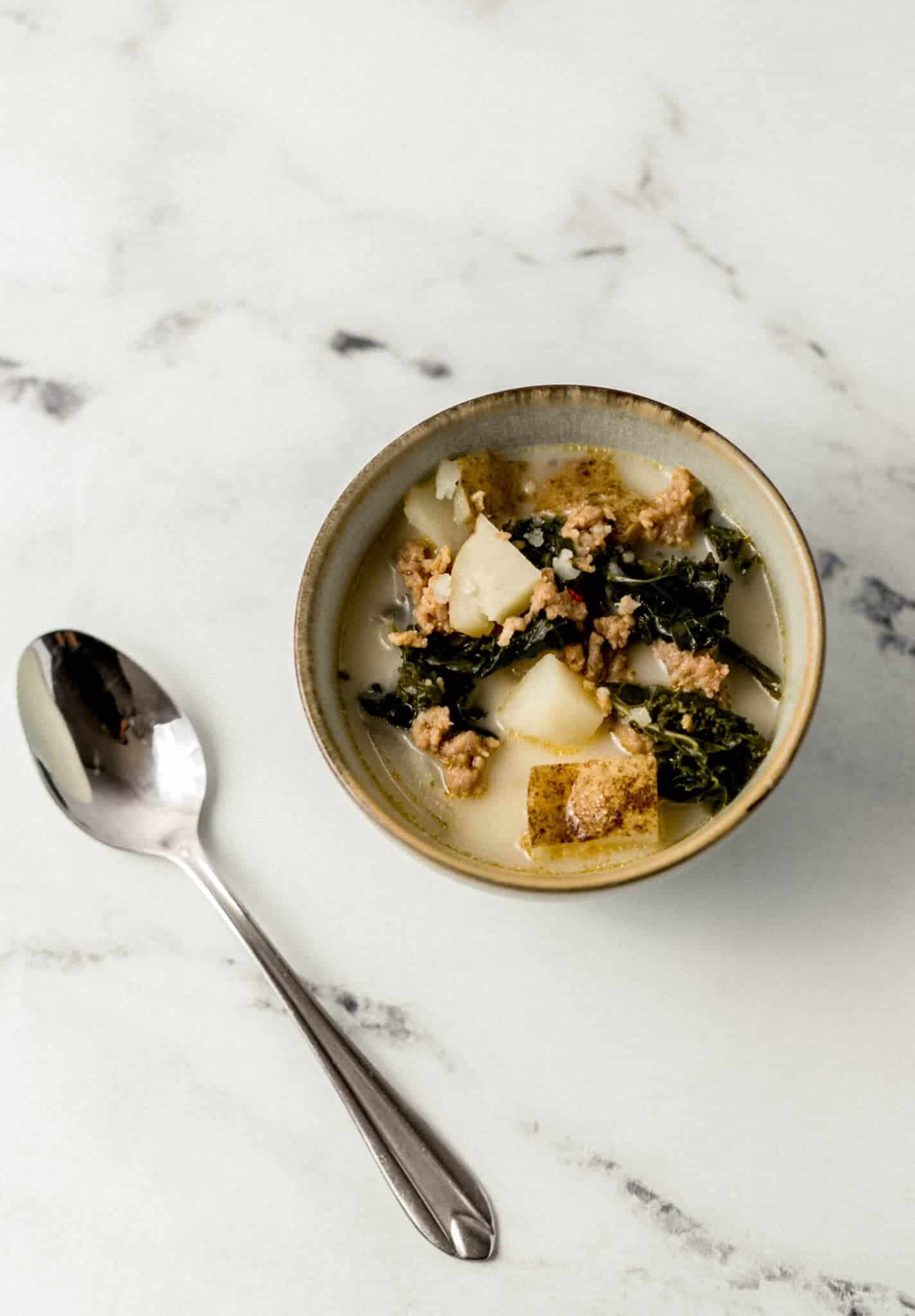 single bowl of soup beside a spoon