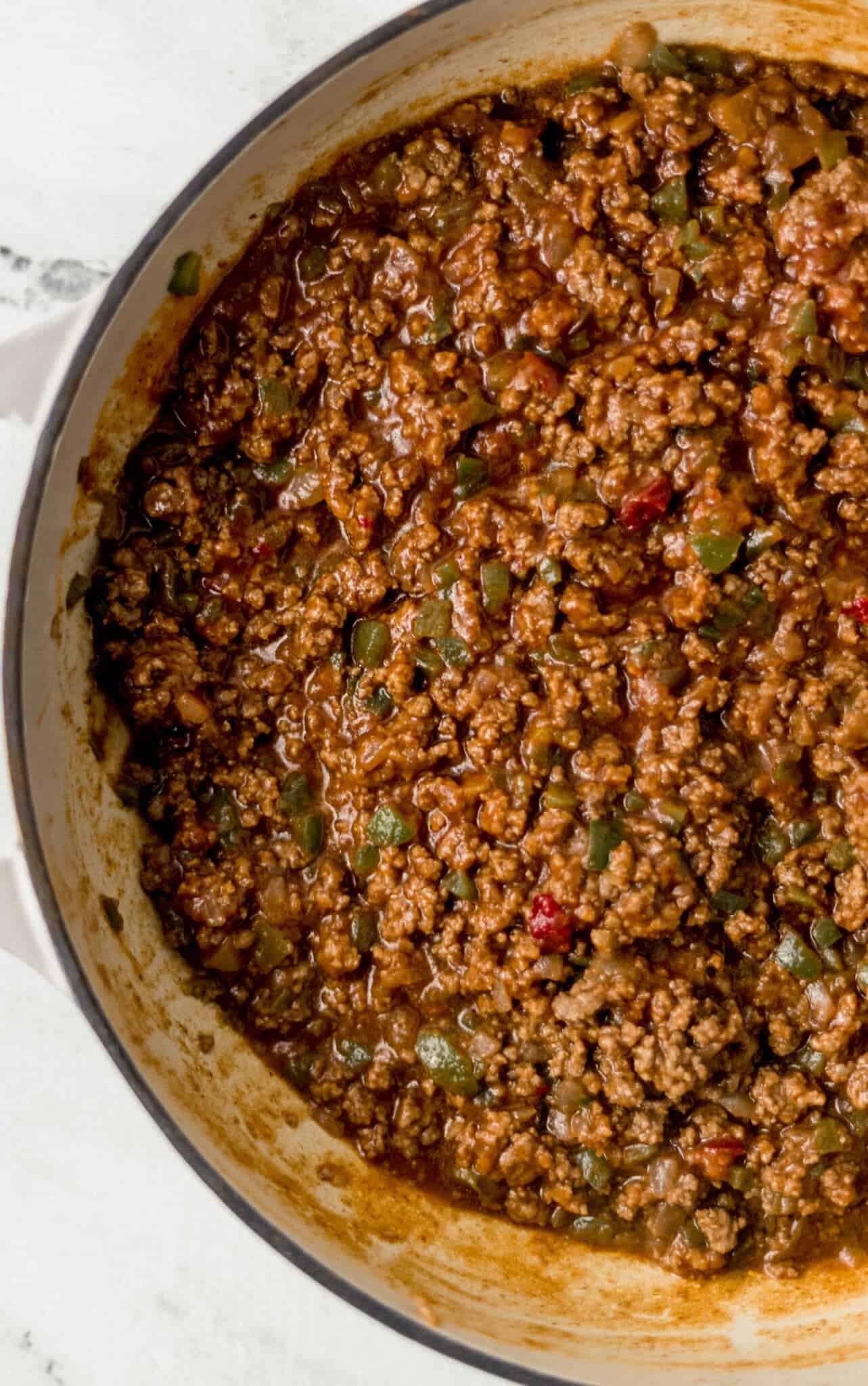 sauce added to meat mixture in large cast iron skillet 