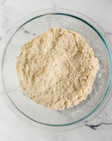 Dry ingredients combined in large glass mixing bowl.