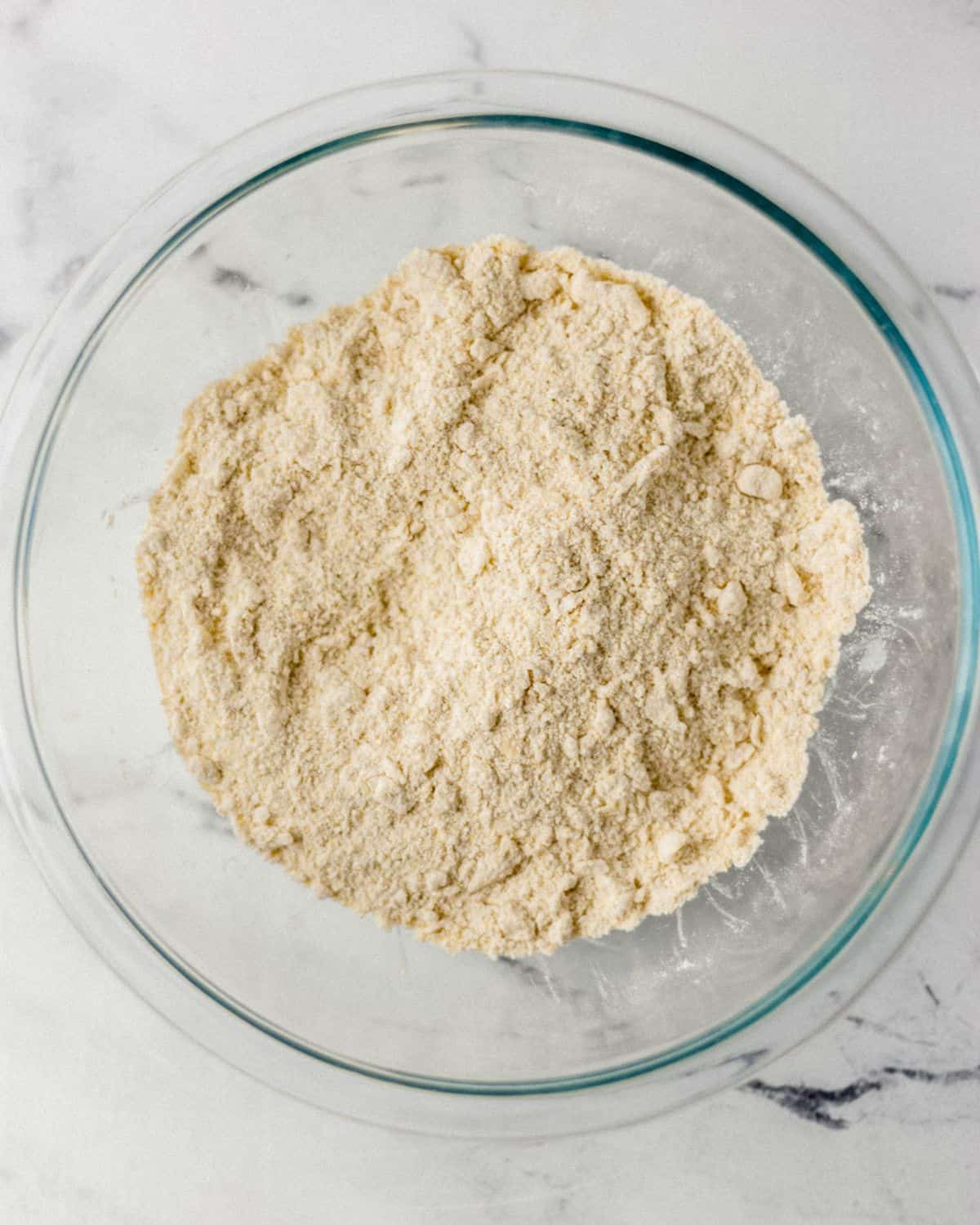 Dry ingredients to make cornbread combined in large glass bowl.