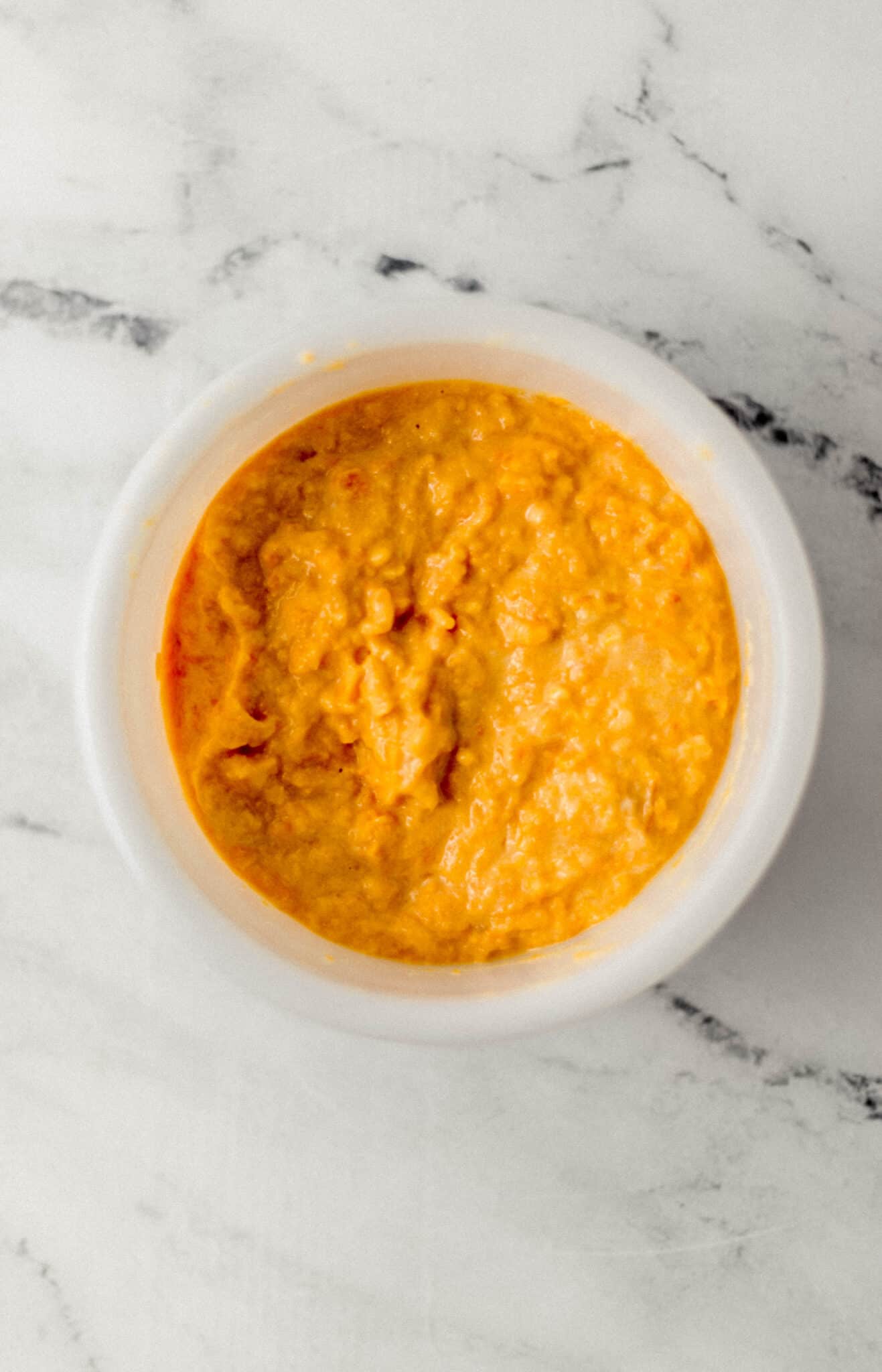 sweet potato, buttermilk, and egg combined in white mixing bowl 