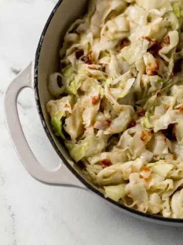overhead view of finished sweet and sour cabbage in large white skillet