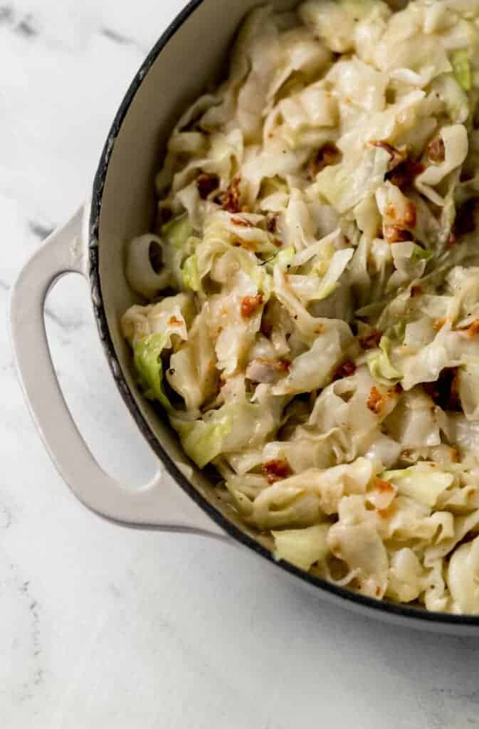 overhead view of finished sweet and sour cabbage in large white skillet