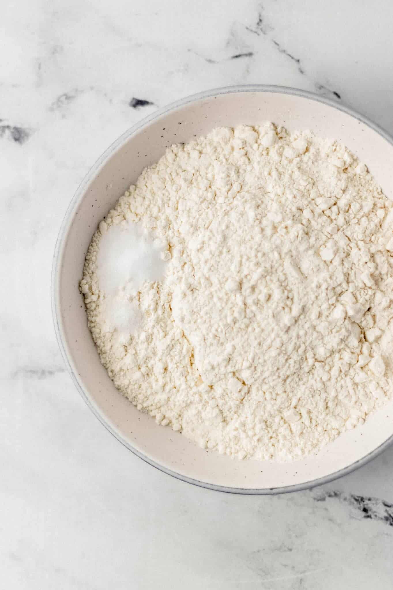 flour, baking soda, and salt in white bowl 