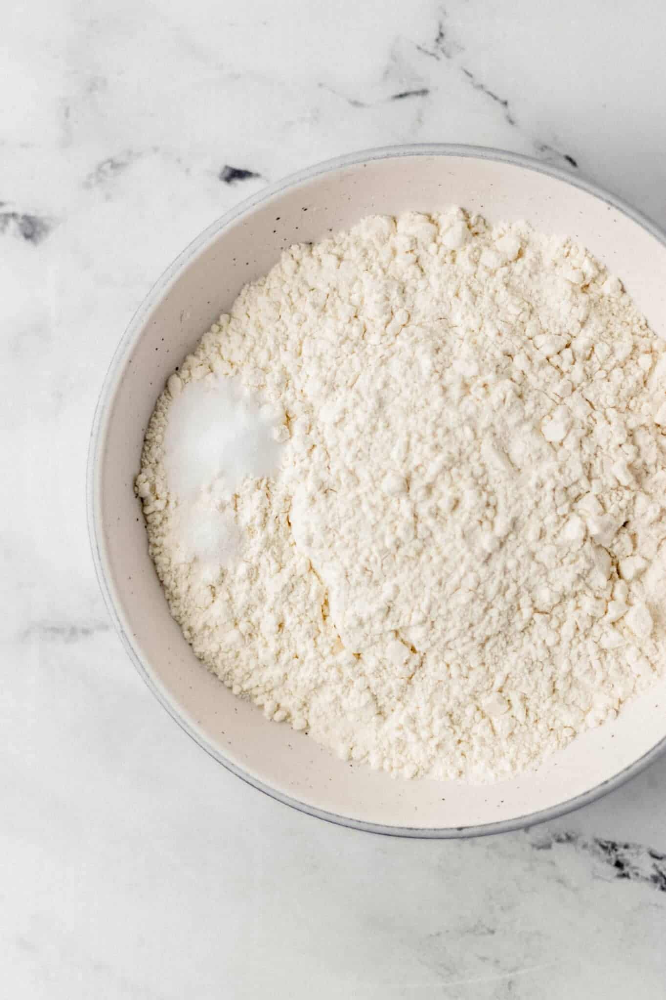 flour, baking soda, and salt in white bowl