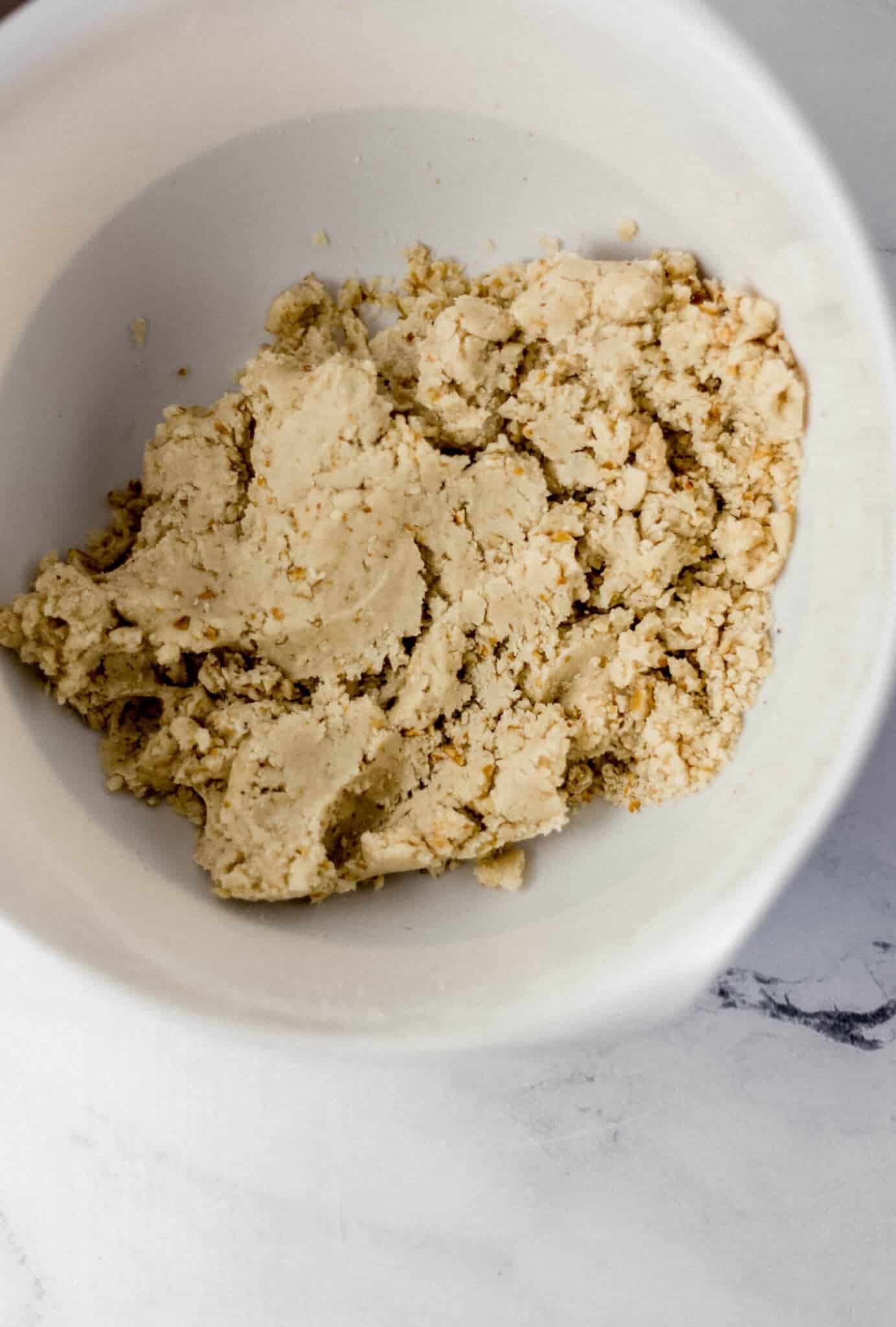 ingredients combined to make cookies in white mixing bowl 