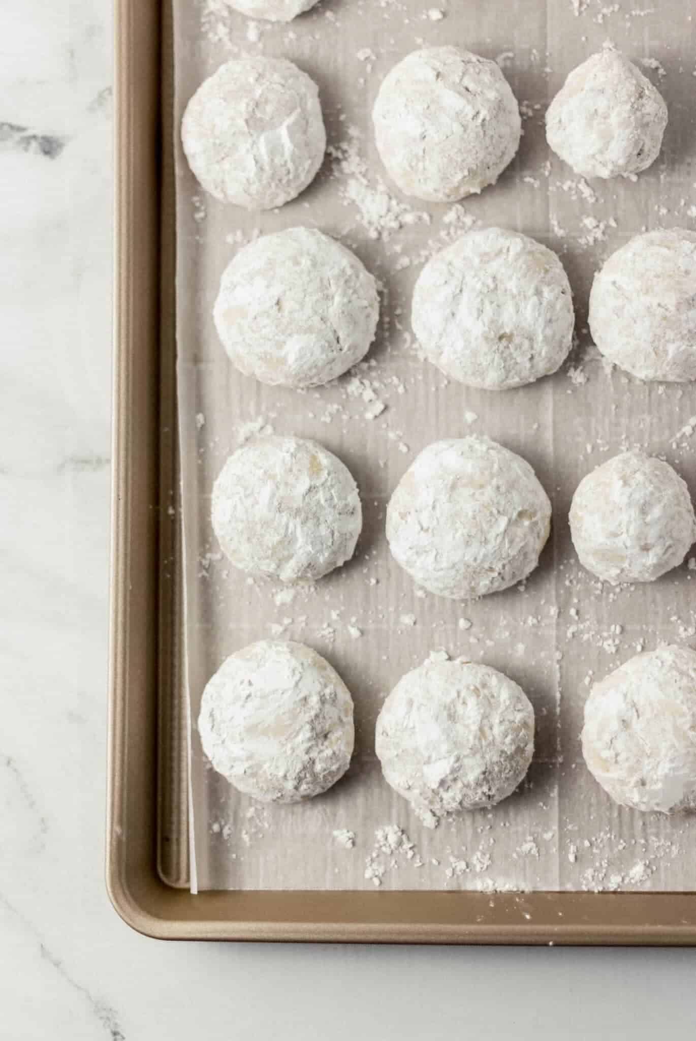 finished tea cakes on parchment lined baking sheet 