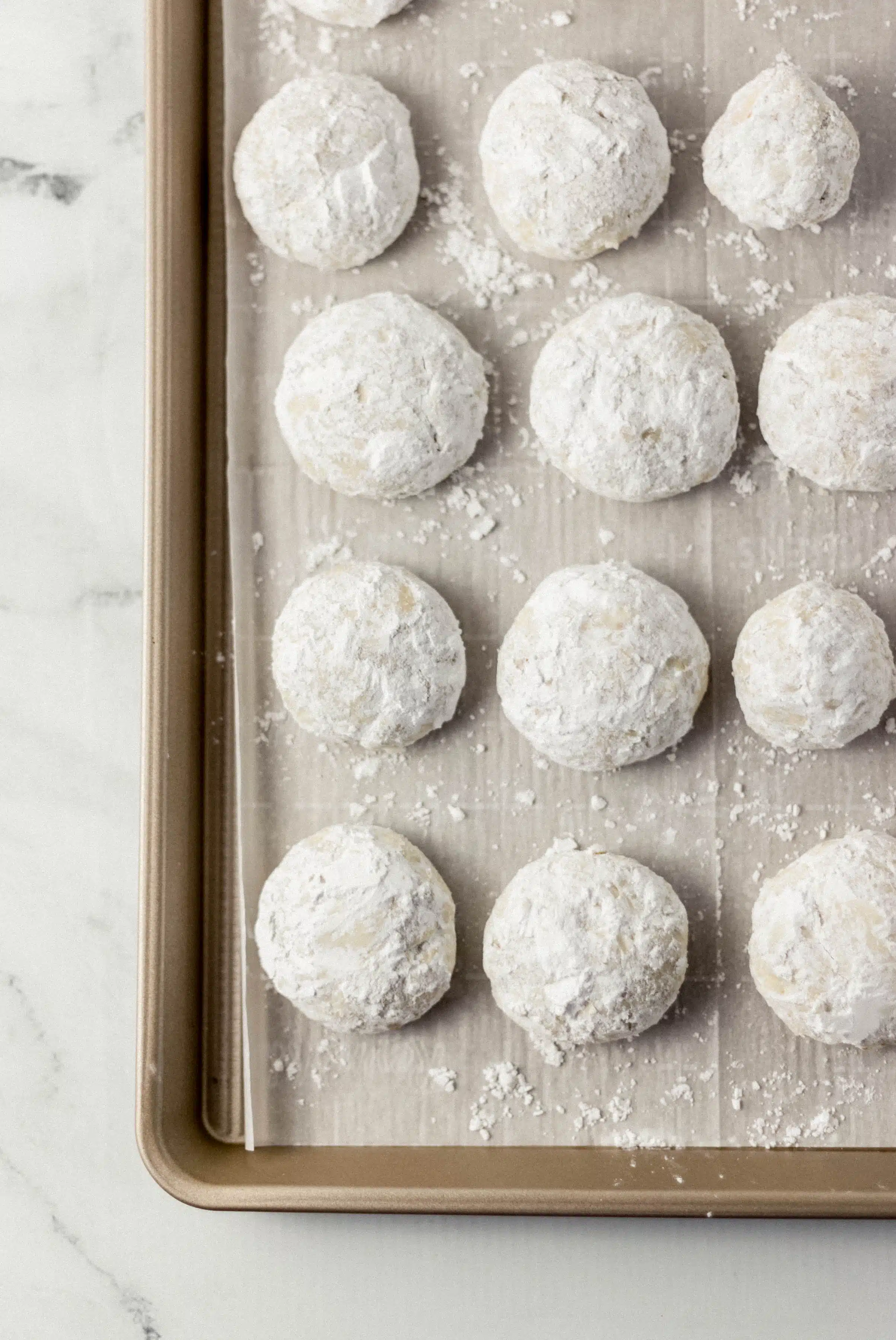 finished tea cakes on parchment lined baking sheet 