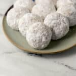 finished tea cakes covered in powdered sugar on a plate